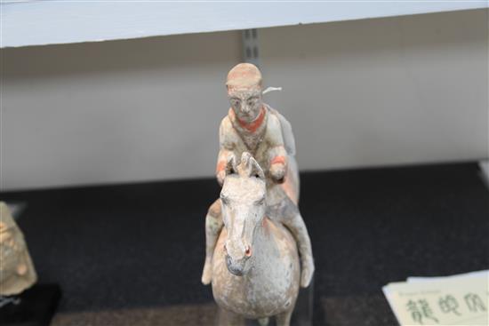 A Chinese pottery group of a horse and rider, Han dynasty, height 35cm, length 33.5cm